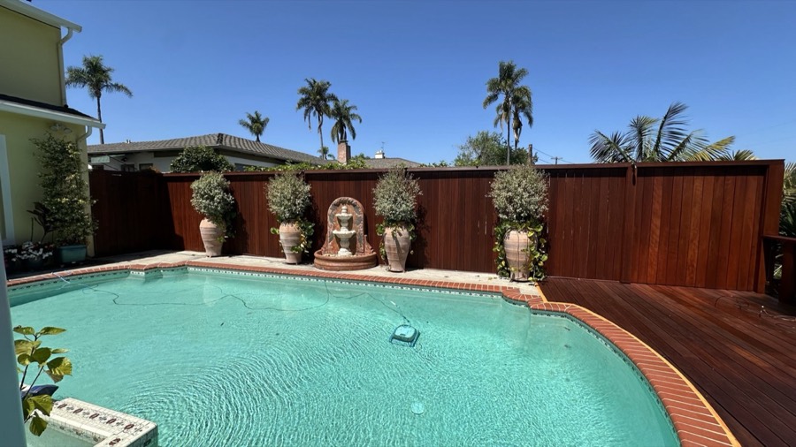 Stained deck and fence by a pool